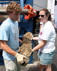 Giora and Kate carry a meter-long carbonate collected during the first dive