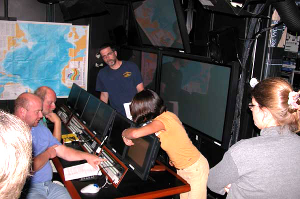 Pamela Lezaeta of the Institute for Exploration coordinates a review of operations in the control van while Timothy Shank, of the Woods Hole Oceanographic Institution, Peter Auster, of the University of Connecticut, Scott France, of the University of Louisiana, and Celeste Mosher, of the University of Maine look on