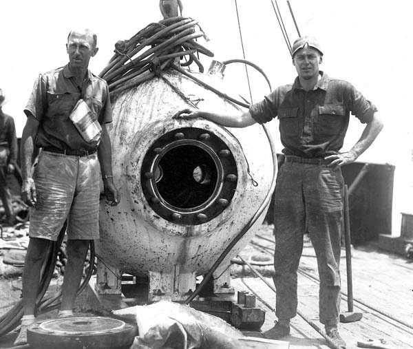 William Beebe (left) and Otis Barton standing next to the bathysphere.