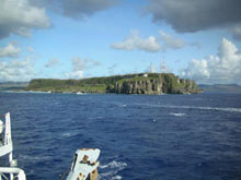 A last glimpse of the island of Guam while heading out of the harbor.