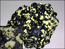 Piece of andesite lava newly formed near Brimstone Pit that shows elemental sulfur infilling the vesicles in the lava.