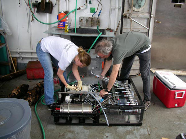 Scientist extract fluid samples from the Hydrothermal Fluid Sampler (HFS) after a Jason dive.
