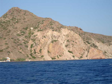 Reddish rhyolitic domes on Milos island.