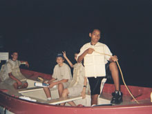 Brandon, David, Cameron and Joseph pose inside a reproduction of a Titanic life boats