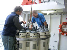 Scientist examine the CTD package before its deployment at Brothers volcano.