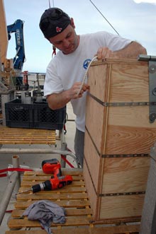 Erik Cordes fashions a plywood box to house a suite of 16 push cores on the elevator.
