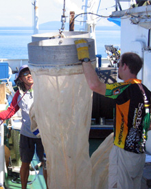 Fig. 1. Val Borja (white shirt) and Nick Loomis, MIT graduate student,
      get ready to lift the bongo nets 