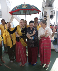 Talina, Caron, and Peggy in borrowed finery amuse our shipmates and
our guests from Tawi-Tawi after the exhibition of traditional Muslim
dances.