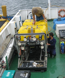 Joe Caba and Toshi Mikagawa connect the Global Explorer ROV to its yellow tether.
