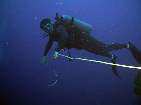 Twilight Zone technical diver Marc Slattery helps lay a guide line along the wall face.