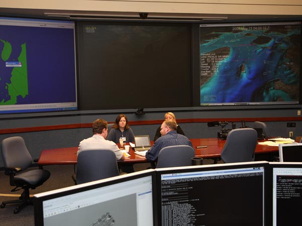 Maritime Archaeologists discuss AUV data in the Integrated Display Center (IDC).