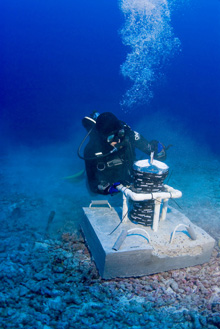 A diver deploying a bottom-mounted Acoustic Doppler Current Profiler (ADCP).