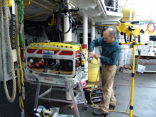 Before leaving port, the ROV was taken for a test run.  Here, Matthew Cook, operations manager for SeaView Systems Inc., preps the ROV for launch.
