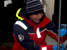 Marlene Jeffries fills a sample bottle with water from a Niskin bottle mounted to the rosette. During the 2009 RUSALCA expedition, she will collect close to 1000 samples, which will be analyzed to reveal the Arctic Ocean's absorption of atmospheric carbon dioxide.