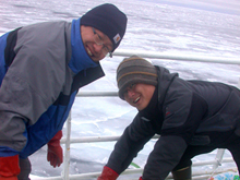 At the northernmost station of the 2009 RUSALCA expedition, Sang Lee and Hyoung Min Joo check that the open-air water baths, where phytoplankton incubate in bottles, are not frozen solid.
