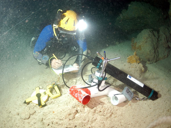 Cave diver Brian Kakuk places a Doppler current meter in a submarine cave. Photo credit: Tamara Thomsen.