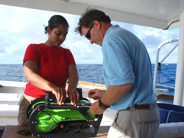 Undergraduate student Alexis Hall helps Dr. Kvitek attach a CTD (conductivity, temperature and depth) sensor to the ROV. The CTD data will help the team gather information about the water column near the potential cave sites.
 