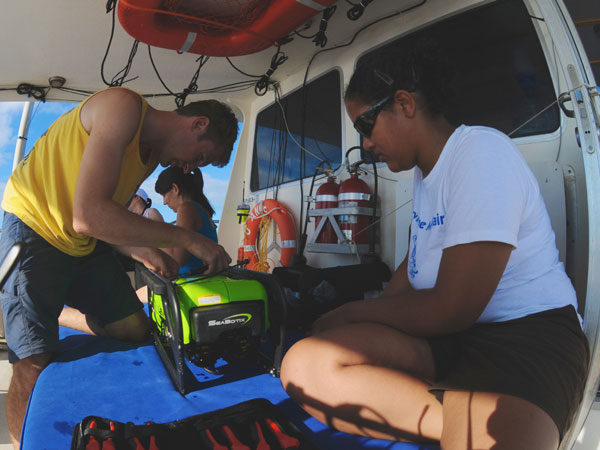Todd Hallenbeck and Alexis Hall work together to troubleshoot and fix a minor problem with the ROV�s thrusters.  