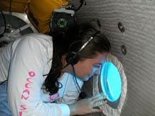 Grad student, Gabby Barbarite, peers out of the aft compartment porthole during her first submersible dive experience.