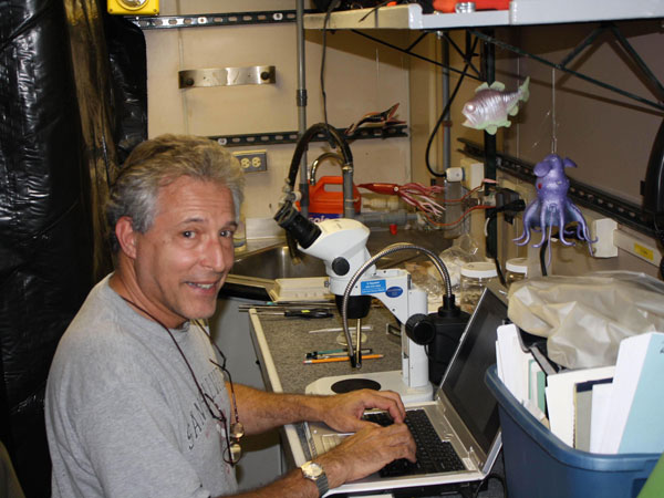 Professor Chuck Messing in his onboard office after discovering the new Crinoid specimen.