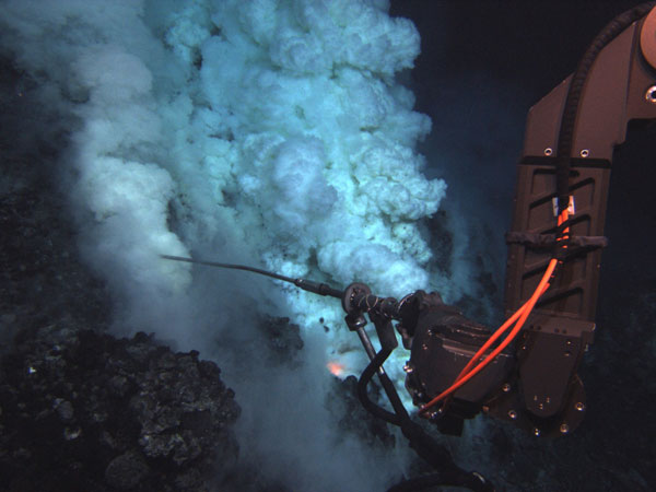 The Jason remotely-operated vehicle (ROV) samples fluid at an eruptive area near the summit of the West Mata Volcano. The fluid sampling wand is approximately three feet long. 
