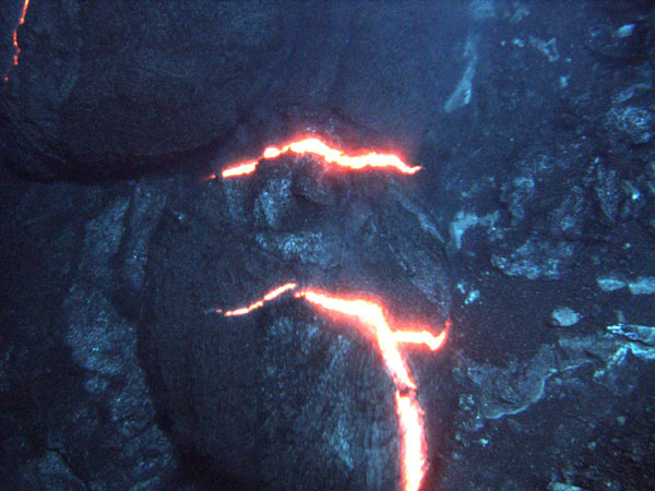 These are consecutive images.  The orange glow of superheated magma, about 2,200 degrees Fahrenheit, is exposed as pillow lavas extrude from the eruption. These images are approximately three feet across in an eruptive area approximately the length of a cross. 