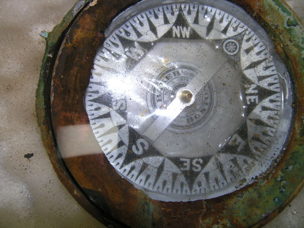 The card of the compass is still intact revealing the manufacturer and date of the compass patent. 