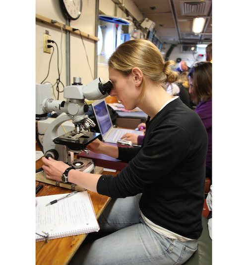 Alexis Pasulka prepares her microscope for the cruise. This involves aligning the halogen bulb and getting the cells on the slide in focus. This microscope has epifluoresecent capabilities, which enables Alexis to look at microorganisms in the water column as well as in the sediments.