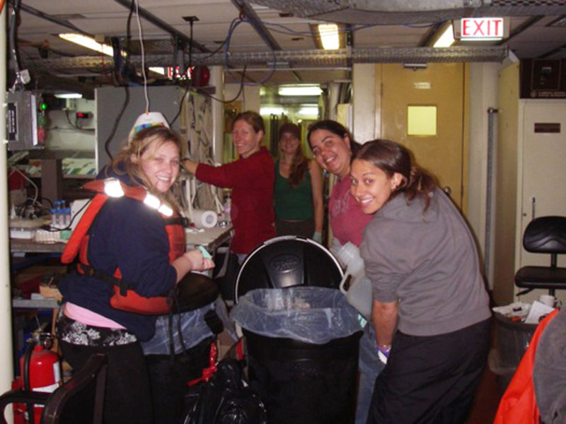 Transferring water to garbage cans for filtration. From left to right: Ashlee, Ally, Christina, Rosa, Monica.