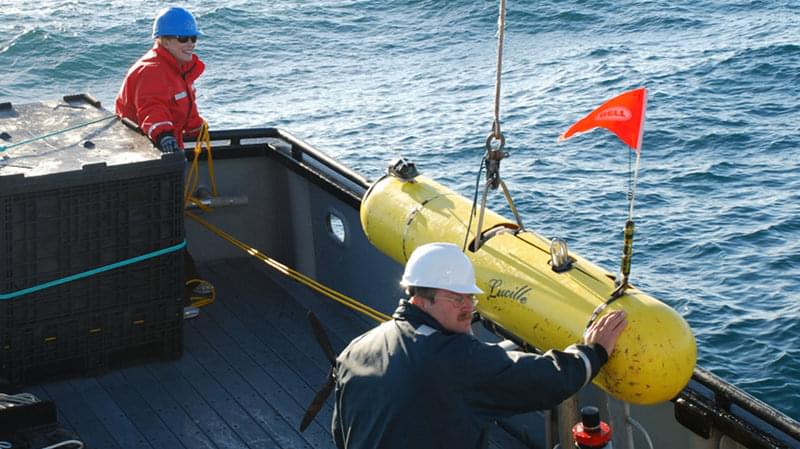 Out on deck, Russell Haner and Elizabeth Clarke make final preparations before deploying the AUV Lucille for a mission.