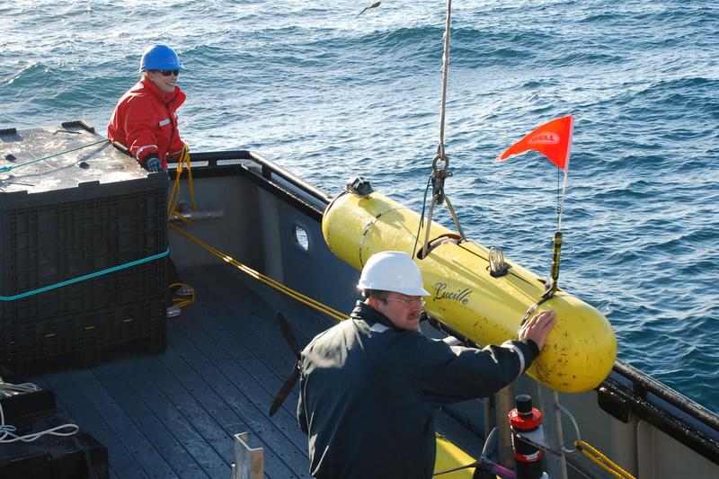 Out on deck, Russell Haner and Elizabeth Clarke make final preparations before deploying the AUV Lucille for a mission.