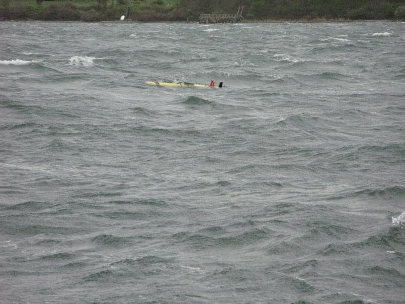 The autonomous underwater vehicle (AUV) is shown here just after it was spotted on the surface. It is relatively easy to see the AUV in this photo. Since the waves are higher that its antennas and fins, the AUV was often hidden by the waves.