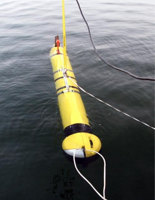 The ATLAS free-swimming underwater vehicle measures 0.3 meters (1 foot) in diameter and 1 m (10 ft) in length. The ATLAS sonar, which is mounted on the nose, views a large and wide area in front of the vehicle. At this moment, the AUV is in a quiet lake and in its pre-release position, where the vehicle and software are in their final check-out. In a moment, the lines will be released and the vehicle will be sent on its way to search the lake floor.