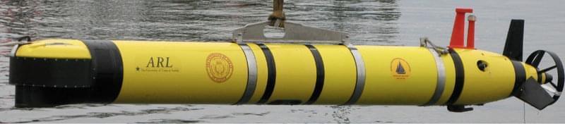 This side-view of the ATLAS autonomous underwater vehicle (AUV) shows the sonar mounted on the nose, the orange GPS/WiFi antenna and strobe light mounted on top, and the fins with propeller at the stern. The underwater modem uses the small black transducer underneath the AUV to transmit and receive acoustic messages between the AUV and support ship.