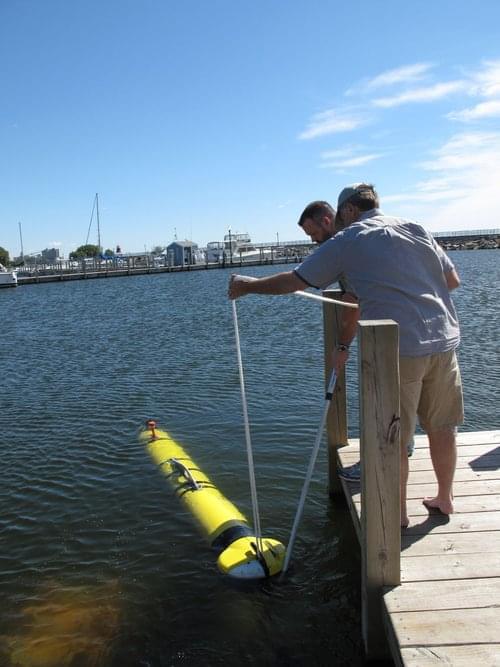 Step 3. After guiding the ATLAS off the trailer, team members detached the rope and used a remote to guide it over to the research vessel (R/V) <em>Storm</em>.
