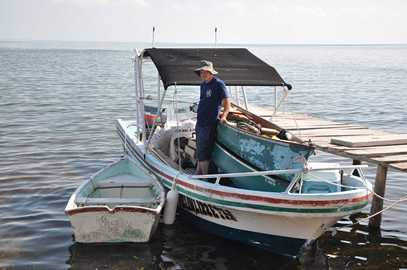 Dan Leonard waits with the loaded-down lancha as the team secures the dinghies next to the boat for the trip to Vista Alegre.