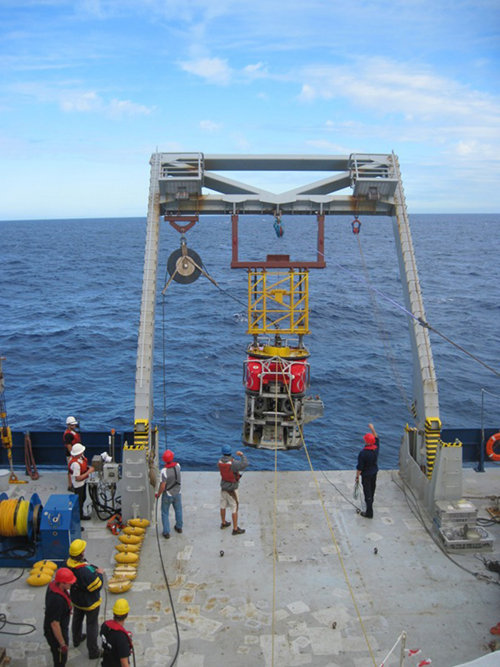 The University of Bremen-based Quest 4000 ROV team lowers the vehicle over the stern of the R/V Roger Revelle for its first dive of the expedition.