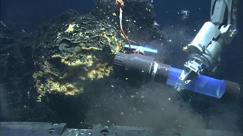 The manipulator arm of the Quest 4000 ROV uses a scoop to sample the microbial mats at Vai Lili.