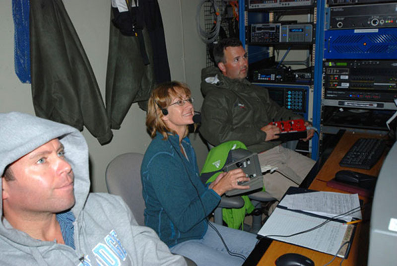 Dr. Sandra Brooke (center, co-chief scientist, MCI & OIMB), Kevin Joy (right, UCONN), and Chris Hartman (DOER) manage the ROV dive from the control van on 18 Aug. 