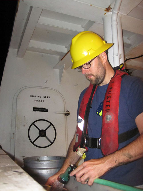 Craig Robertson rinsing the silt from some of the benthic infauna he collected using the Box Corer.