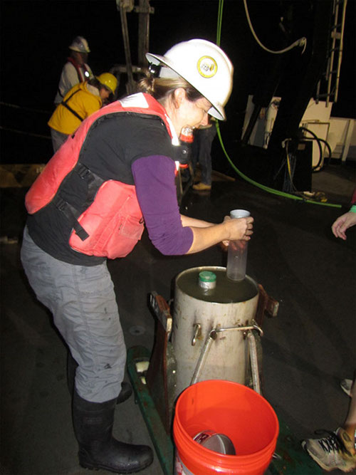 Principle Investigator, Amanda Demopoulos, pushing smaller cores into the mud retrieved from the bottom. (Note the smile! Dr. D. loves the mud!)