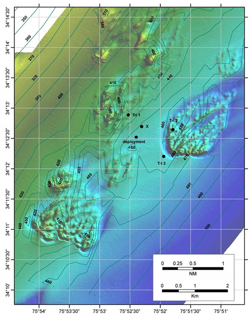 Multibeam sonar map of a deep-sea coral area off Cape Lookout, North Carolina. The black dot near the center marked 'deployment' is the surface position where a benthic lander was dropped. Three dots marked 'Tri 1-3' are surface locations used to take range data to the lander. The dot marked 'ÍX' is the bottom position for the lander calculated from the range triangulations.