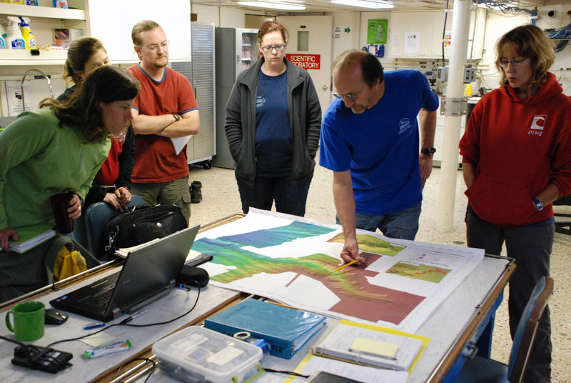 Co-Chief Scientist Steve Ross identifies targets for the first ROV dive at the nightly science meeting.