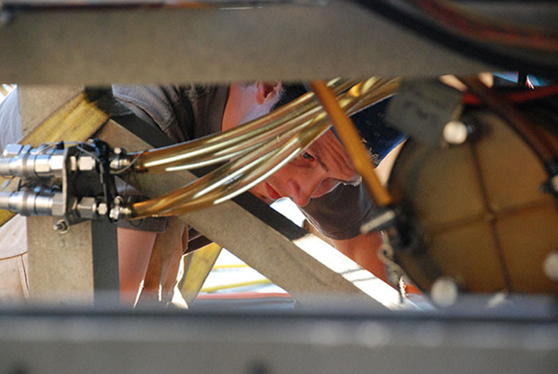 Eddie Dow checks to make sure all of the systems on ROV Jason are prepared for the dive.