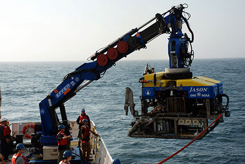 Graduate students Esprit Saucier, Alanna Casey, and NOAA Office of Ocean Exploration and Research archaeologist Frank Cantelas work with ROV Jason team