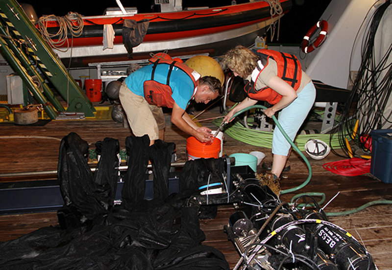 Rinsing one of the MOCNESS nets with seawater to flush the contents