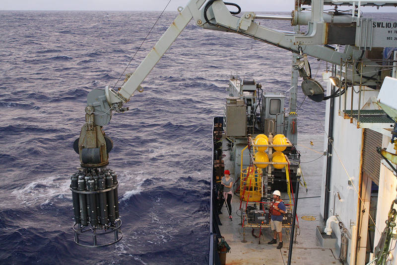 The CTD instrument package is launched over the side of the ship to search for hydrothermal plumes at Ahyi seamount.