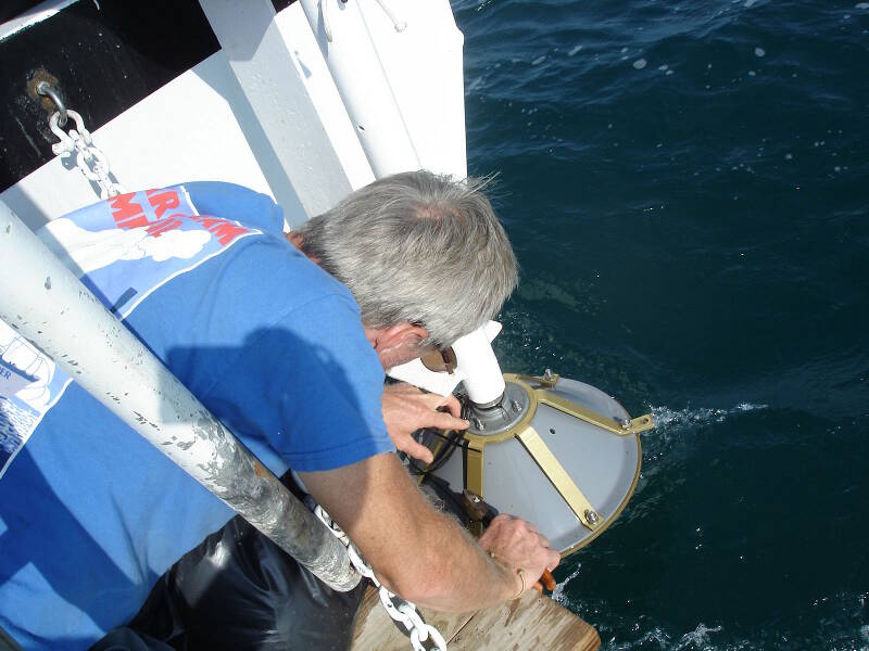 Dr. Turner securing the subbottom transducer at the stern of the boat.