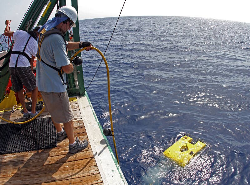 The remotely operated vehicle moves away from the research vessel after hitting the water.