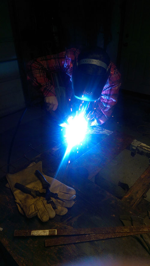 Grace welding a side of the frame.